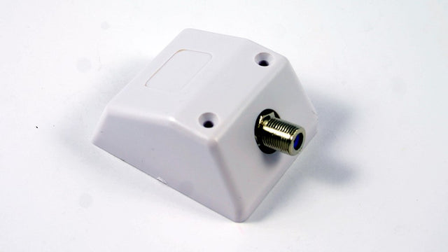 TV skirting mount with F connector installed at wall base providing neat antenna cable connection point for TV setups